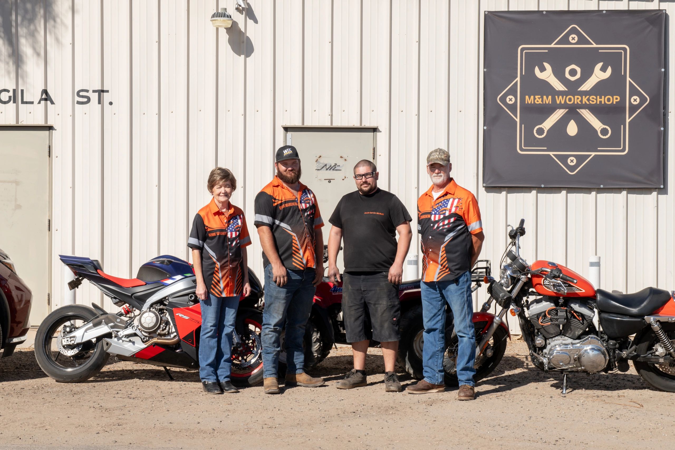 The M&M Workshop team in front of the shop
